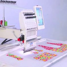 a machine that is sitting on top of a table with some type of stickers