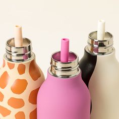 three different colored bottles sitting next to each other