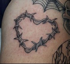 a heart shaped tattoo with barbed wire around it