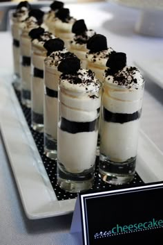 small desserts are lined up on a long serving platter with black and white toppings