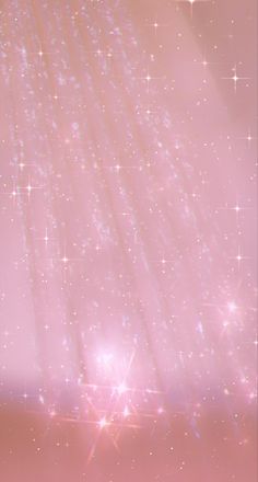 an abstract pink background with stars and sparkles