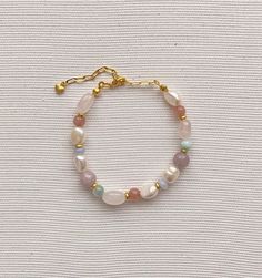 Pearl bracelet Freshwater pearl jewelry Rainbow, soft bracelet features Baroque pearls Multi-colored natural stone (pink quartz, chalcedony,larimar, kunzite and jade) Gold plated brass clasp Length - 16-22 cm(Adjustable) Pearl and stone vary in size and shape Please contact us for specific questions, size, color, etc. -Care -Delicate Jewelry, Especially Dainty Chain Designs, Should be Treated with Care While Wearing to Prevent Breakage. -Many factors can influence the condition of the jewelry. T Natural Stones Pearl Bracelet As A Gift, Pearl Bracelet With Natural Round Beads, Natural Stone Pearl Bracelet With Round Beads, Dainty Pearl Bracelet With Natural Stones As Gift, Dainty Pearl Bracelet With Natural Stones, Dainty Natural Stone Pearl Bracelet Gift, Pearl Bracelets With Natural Stones For Gift, Pastel Bracelet Jewelry As Gift, Pearl Gemstone Bracelets As A Gift