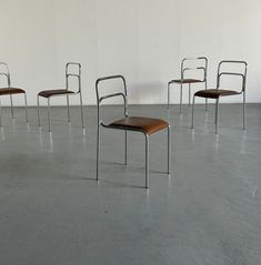 four chairs in a room with one chair on the floor and two empty chairs to the side