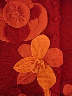 an orange flower on a red background