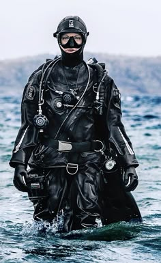 a man in scuba gear walking through the water