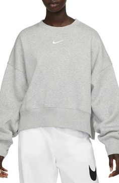 An embroidered Swoosh adds minimal branding to this cozy fleece sweatshirt cut for a relaxed, oversized fit that's enhanced by the dropped shoulders. 22" length (size Medium) Crewneck 80% cotton, 20% polyester Machine wash, tumble dry Imported Nike Trends, Sweatshirts Nike, 2024 Clothes, Nike Sportswear Phoenix Fleece, Nike Crewneck Sweatshirt, Ski Team, Nike Crew Neck, Nike Sportswear Women, Clothes Wishlist