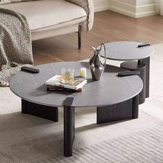 two coffee tables sitting on top of a carpeted floor