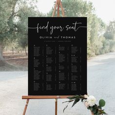 a black and white wedding seating plan on an easel