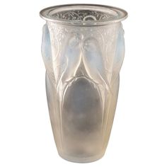 an ornate glass vase is shown on a white background