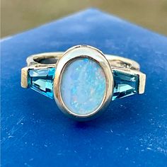 This Vintage 14k Ring Is A Beautiful Piece Of Jewelry With A Unique Design. I Bought It Over Thirty Years Ago, And Just Had It Professionally Polished And Settings Checked. The Main Stone Is A Stunning Blue Opal, And It Is Surrounded By A Bezel Setting That Gives It A Classic Look. The Ring Also Features Blue Topaz Side Accents That Add A Touch Of Rich Color To The Piece. No Inclusions. *This Is My Lowest Offer, As The Price Reflects A Tremendous Discount Over Its Value. Thank You So Much. Blue Multi-stone Opal Ring Fine Jewelry, Blue Multi-stone Opal Ring In Fine Jewelry Style, Fine Blue Opal Multi-stone Ring, Luxury Blue Opal Ring For Anniversary, Blue Opal Ring With Accent Stones, Blue Opal Ring With Gemstone Accents For Anniversary, Source Unknown, Topaz Ring, Blue Opal