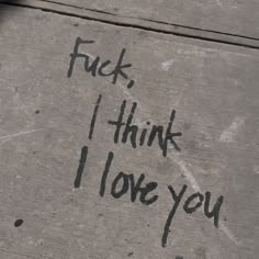 graffiti written on the side of a cement wall that says, f k i think i love you