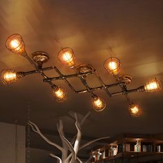 a chandelier hanging from the ceiling in a room with bookshelves and lamps