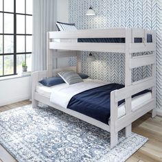 a white bunk bed sitting on top of a wooden floor next to a blue rug