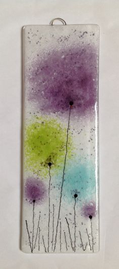 a piece of glass with flowers painted on it