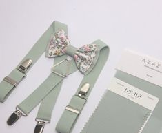 This Floral dusty sage green tie/bow tie  is a Wedding Favorite ~it  is perfect for weddings or special occasions. Fabric: linen / cotton floral  Fabric Care: Dry-clean Only The width of suspenders: 2.5cm/1 inch Return Policy: If you are unhappy with your item, be it damage, defect or otherwise, we will happily accept a return/exchange.  Returns must be unworn, unwashed, undamaged, and unaltered. Items not in this condition can not be returned. All orders  will require the customer to ship at th Sage Green Wedding Ring Bearer, Green Bow Tie For Summer Wedding, Green Bow Tie For Wedding And Father's Day, Sage Green Suspenders Wedding, Green Summer Wedding Bow Tie, Sage Green Bow Tie, Adjustable Green Bow Tie For Wedding, Sage Green Bow Tie And Suspenders, Green Bow Tie And Suspenders