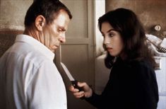 a man holding a knife next to a woman