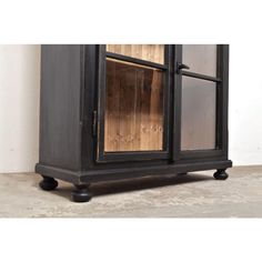 an old black cabinet with glass doors