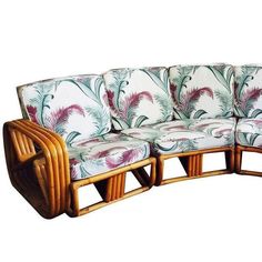 an image of a couch that is in the shape of a curved sofa with palm leaves on it