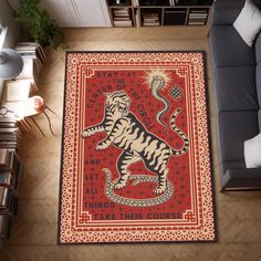 a rug with a tiger on it in the middle of a room next to a couch