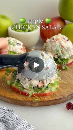 an apple and chicken salad on a cutting board