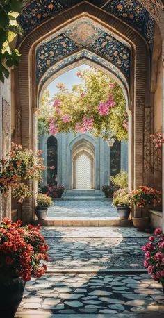 an archway with flowers and potted plants on either side