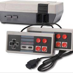 an old nintendo game console with two controllers attached to the controller board and power cord