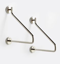 two metal hooks are attached to the wall