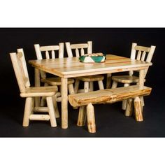 a wooden table and chairs with a green bowl on top of the table in front of them