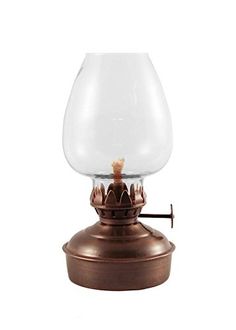 an old fashioned oil lamp with a glass shade on it's top and metal base