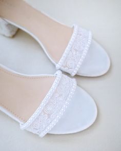 a pair of white shoes sitting on top of a table