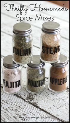 five jars filled with spices sitting on top of a white wooden table next to the words, thrifty homemade spice mixes