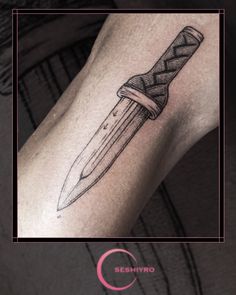 a knife tattoo on the arm