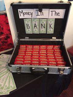 a briefcase filled with lots of money sitting on top of a black table covered in cards