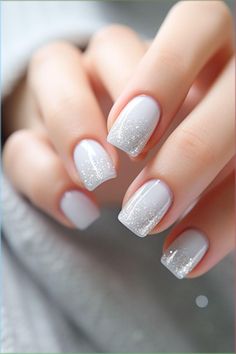 Indulge in the magic of the holidays with this enchanting snow-inspired manicure! The pristine white nails are transformed into a frosty canvas for dazzling glitter and intricate designs, capturing the elegance of a white Christmas with a sprinkle of New Year's glamour. Let your fingertips sparkle and shine as you embrace the festive season ahead! ✨ Nails White Sparkle Glitter, Dip Manicure Wedding Nails, Frosty Nail Designs, White Gel Nails With Glitter, Icy Winter Nails, White Snow Nails, Icy Nails Winter, Glittery White Nails, Christmas Sparkle Nails