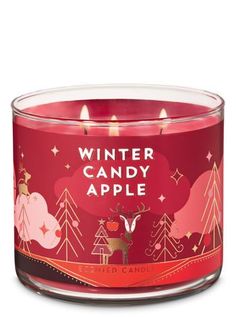 a red candle that is sitting in front of a white background with the words winter candy apple on it