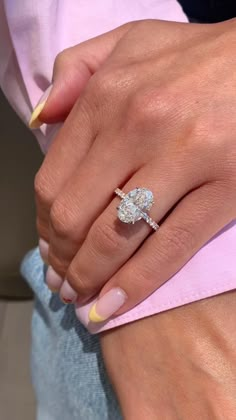 a woman's hand with a diamond ring on it