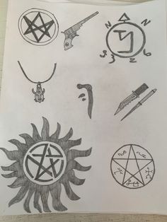 a sheet of paper with various symbols drawn on it, including pen and ink drawing