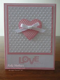 a card with a heart and bow on it