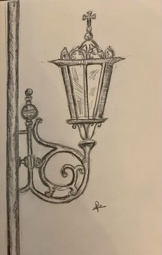 a drawing of a lamp post with a cross on it