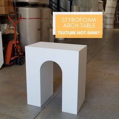 a white table with an orange sign that says strofoam arch table texture not shiny