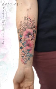 a woman's arm with flowers and an arrow tattoo on the left side of her arm