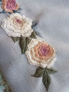 some flowers are on the side of a piece of cloth