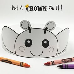 a paper crown with crayons next to it on a white surface and the words put a crown on it