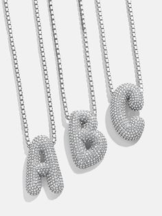 Orders placed between 11/30 - 12/6 will be ship between 12/28 - 1/3/25.Opt for this classic initial necklace with a modern twist. The Pavé Bubble Initial Necklace features a box chain attached to an initial crystal pendant. Each letter is crafted in a fun, 3D-inspired bubble font. Choose your initial or that of a loved one and stack it every single day. Bubble Letter Necklace, Letter Necklace Silver, Initial Necklace Silver, Silver Bling, Bubble Necklaces, Initial Pendant Necklace, Bubble Letters, Initial Pendant, Letter Necklace