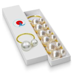 an open box with some pearls in it