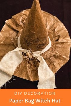 a brown paper bag hat sitting on top of a black surface with the words, how to make paper bag witch hat