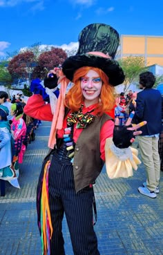 a woman with red hair and makeup dressed in costume