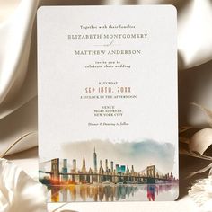 a wedding card with the city skyline painted on it