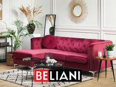 a living room with a pink couch and coffee table in front of a white wall