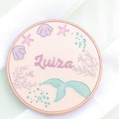 a pink and blue mermaid themed embroidery with the word julia on it